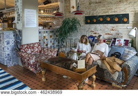 Estonia, Viljandi, September, 2022: Visitors To The Cozy Restaurant Fellin Look Through The Menu To 