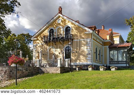 Estonia, Viljandi, September, 2022: Beautiful Yellow Renovation House Under Red Tiles With Glass Ver