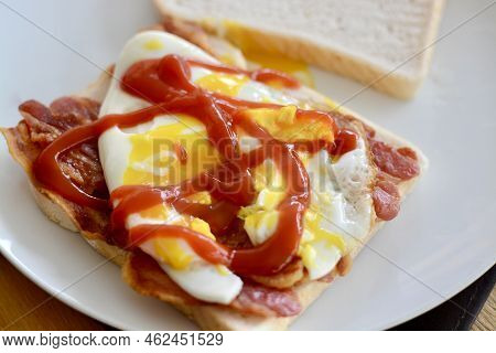 Bacon And Egg Open Sandwich With Tomato Ketchup Served On White Bread