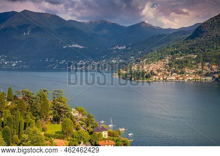 Idyllic Lake Como Coastline With Village And Boat At Dramatic Sunset, Northern Italy