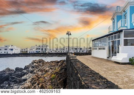 White Architecture On Black Volcanic Rocks In Corralejo, Lanzarote, Spain