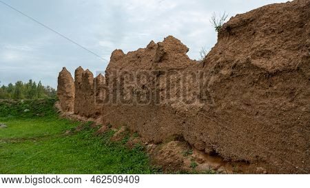 Close-up Background Of The Wall Of An Old House Made Of Clay Mixed With Straw. Old Type Of Construct