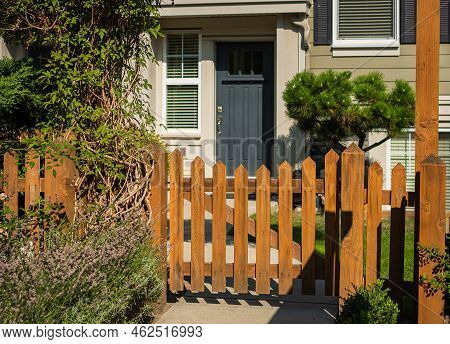 Entrance To A Home Through A Beautiful Green Garden With Flowers, Plants Leading To Entrance Of A Ho