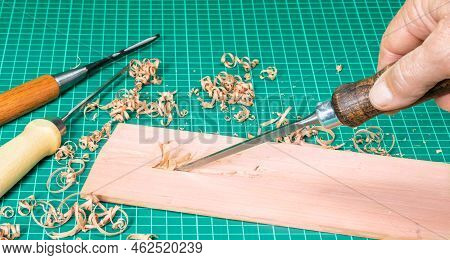 Planing A Narrow Chisel Plank Of Pink Pear