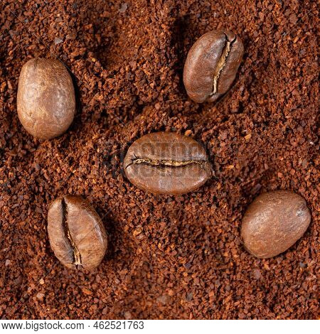 Three Coffee Beans Lie On Ground Coffee Close-up.