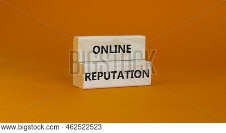 Online Reputation Symbol. Wooden Blocks With Concept Words Online Reputation On Beautiful Orange Bac