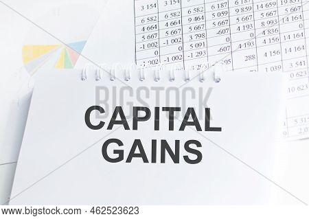 Capital Gains Text Concept On Notepad On The Table Among Documents, Business Concept