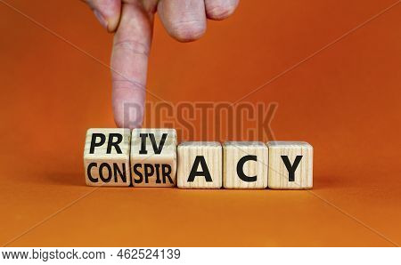 Privacy Or Conspiracy Symbol. Businessman Turns Wooden Cubes And Changes The Word Conspiracy To Priv