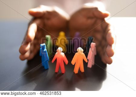 Inclusion And Diversity. Hand Protecting Inclusive Equal Pawns