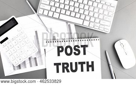 Post Truth Text Written On A Notebook On Grey Background With Chart And Keyboard, Business Concept