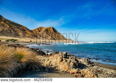 Steep Mountains At Tora Beach On The Remote Deserted Wild Rugged East Coast Of The Wairarapa