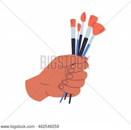 Hand Holding Paintbrushes Bunch With Different Bristles. Artists Arm Squeezing Many, Lot Of Paint Br