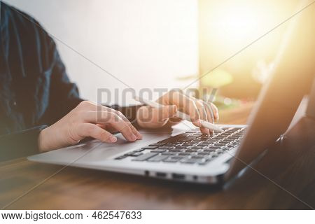Business Concept. Woman Using Laptop To Work On Office Desk.