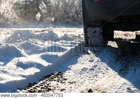 Car Wheels Snow Close-up. Driving On A Winter Road. Winter Tires Shooting From A Lower Angle. The Co