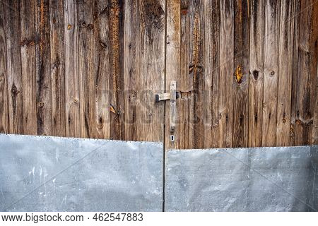Unvarnished Antique Wooden Door With Metal Plate