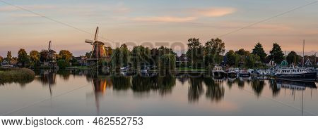 Panorama Of Weesp, View Of The Historical Windmills Along The River Vecht In The Evening