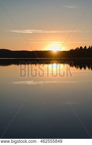 Sunset With Reflection On A Swedish Lake In Smalland. Romantic Evening Mood. Landscape Shot From Sca