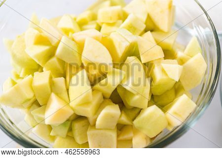 Measured Ingredients In A Glass Mixing Bowl To Prepare Apple Sharlotka Muffin.