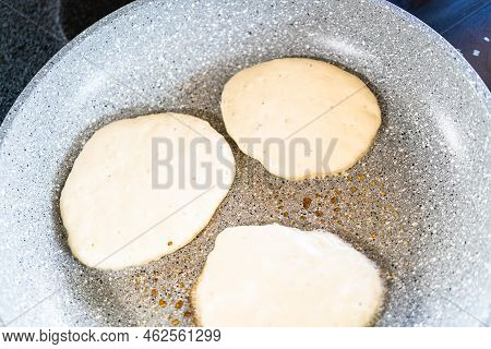 Frying Kefir Based Pancakes In Cooking Pan On An Electric Stove.
