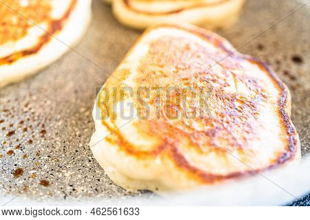 Frying Kefir Based Pancakes In Cooking Pan On An Electric Stove.