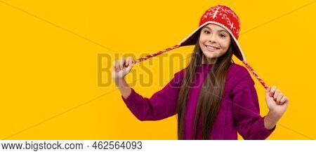 Happy Child In Earflap Hat. Kid Wear Warm Knitted Clothes On Yellow Background. Banner Of Christmas 