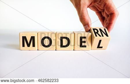 Modern Model Symbol. Businessman Turns A Wooden Cube And Changes The Word Model To Modern. Beautiful