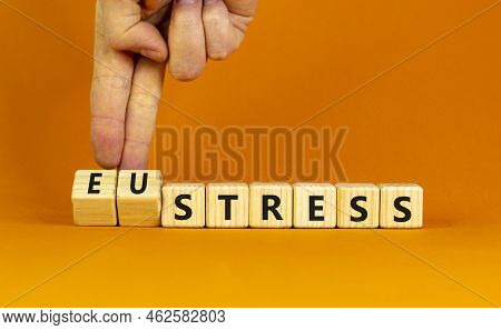 Eustress Or Stress Symbol. Psychologist Turns Cubes And Changes The Concept Word Eustress To Stress.