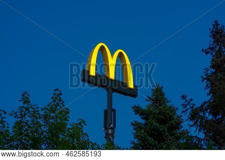 Oldenzaal, Neherlands- June 16, 2022: Well Known Mcdonalds Logo High Above The Trees At Sunset