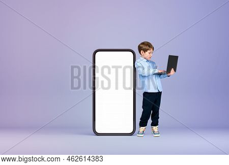 Handsome Young Boy Wearing Formal Wear Is Standing Holding Laptop Near Large Empty White Mockup Smar