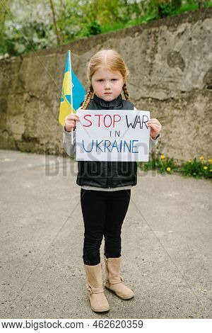 Upset Poor Toddler Girl Kid Protesting War Conflict Raises Banner With Inscription Message Text Stop