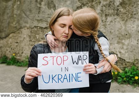 Portrait Little Upset Girl With Mother Calls No War, Raises Banner With Inscription Stop War In Ukra