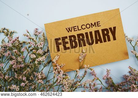 Welcome February Written On Paper Card With Flower Frame Decoraton On Pink Background