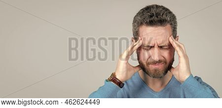 Mature Man With Beard Suffer From Headahce On Grey Background, Health. Man Face Portrait, Banner Wit