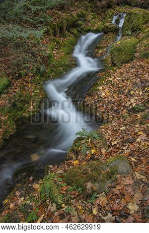 Beautiful Waterfall Landscape Image In Vibrant Autumn Woodland In Lake District