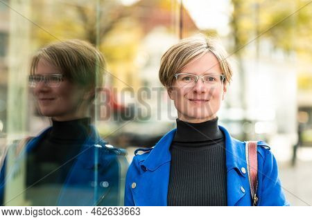 Rtrait Of An Attractive Thirty Year Old White Business Woman Reflecting In A Modern Offce Building, 