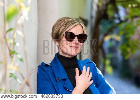 Portrait Of An Attractive Thirty Year Old White Woman Posing In A Narrow Street, Brussels