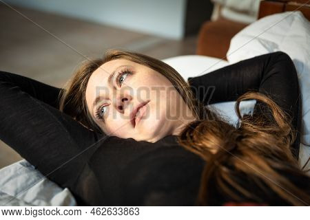 Relaxed Portrait Of An Attrractive Woman, Lying On Her Sofa, Brussels, Belgium