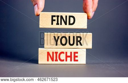 Find Your Niche Symbol. Concept Words Find Your Niche On Wooden Blocks. Businessman Hand. Beautiful 