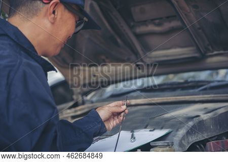 Car Mechanic Man Hand Checking Dipstick Engine Oil Car Mechanical On Site Service. Close Up Hand Man