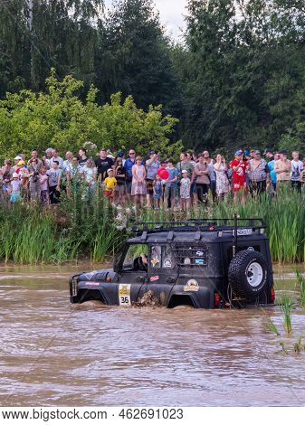 Russia - August 12, 2023, Tver. The Car Overcomes Difficult Obstacles. Large-scale Sports Competitio