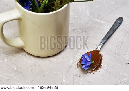 A Spoon With Chicory Flower And Chicory Powder And Chicory Flowers In A Coffee Mug