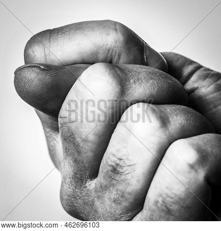 Fist With The Thumb On A White Background