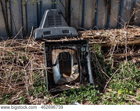 View Of Old Tv Broken Into Pieces Thrown Out In Nature Near A Fence. Discarded Electronics. Concept 