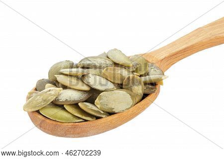 Pumpkin Seeds In Wood Spoon Isolated On A White Background. Green Pepita Seeds. Full Depth Of Field.
