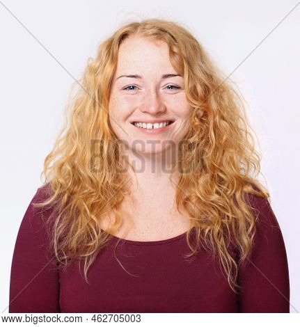 Pleased Redheaded Woman With Beautiful Long Hair