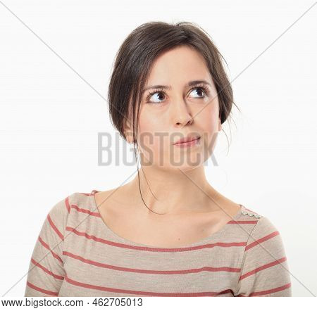 An Attractive Young Woman Looking Up And Thinking About Something