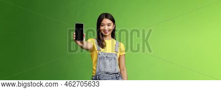 Self-assured Attractive Asian Brunette Show Smartphone Screen, Introduce New Telephone Appllication,