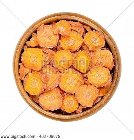 Dehydrated Carrot Slices In A Wooden Bowl. Dry Disks Of Daucus Carota, A Root Vegetable With Orange 