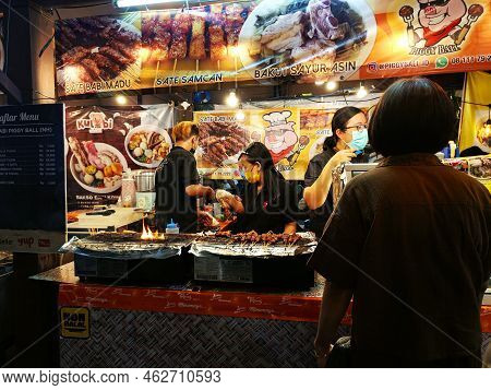 North Jakarta, Indonesia - September 24, 2022: Two Chefs Are Preparing Traditional Indonesian Satay 