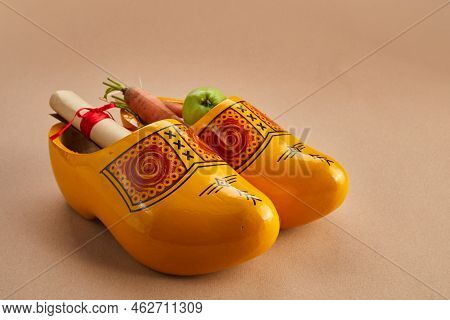 Saint Nicholas - Sinterklaas Day With Shoe, Carrot And Apples On Caramel Background